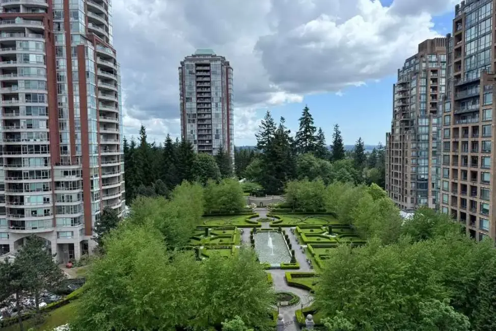 An aerial view of a lovely stratum environment in a residential community featuring shared green areas, paths, and beautifully groomed lawns.