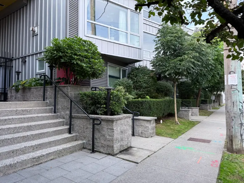 A multi-unit residential property's lawns, hedges, and common walkways are maintained by a strata landscaping firm.
