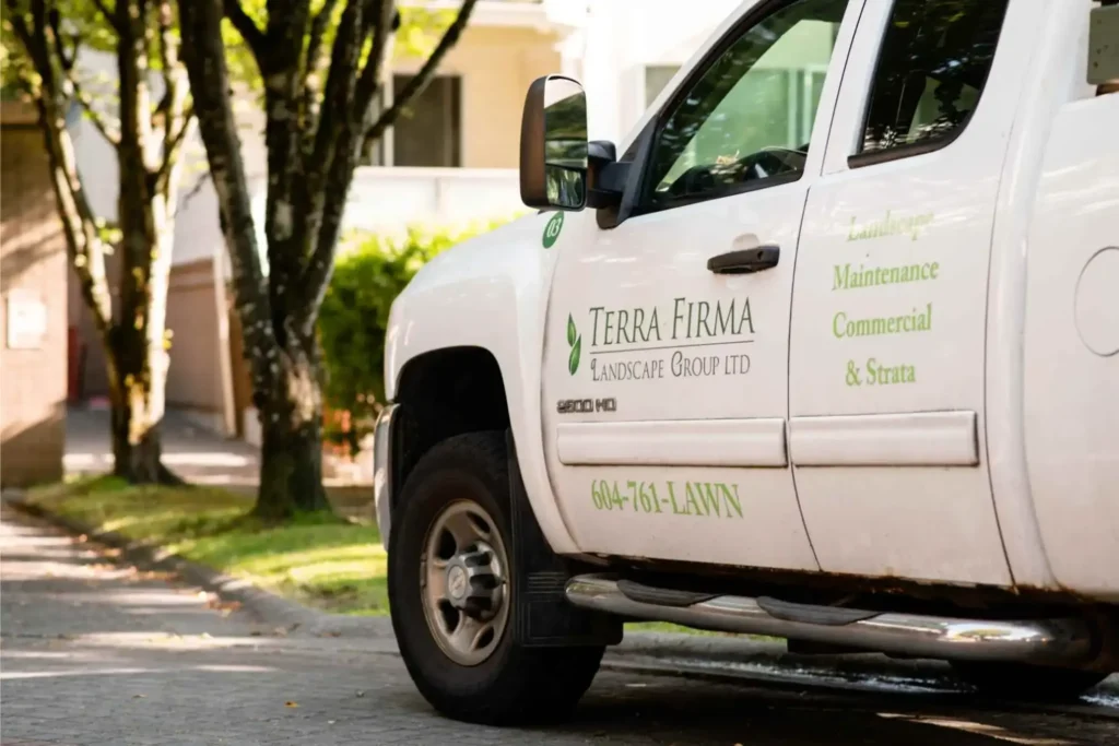 Terra Firma company truck parked outside, branded vehicle representing professional landscaping and maintenance services.